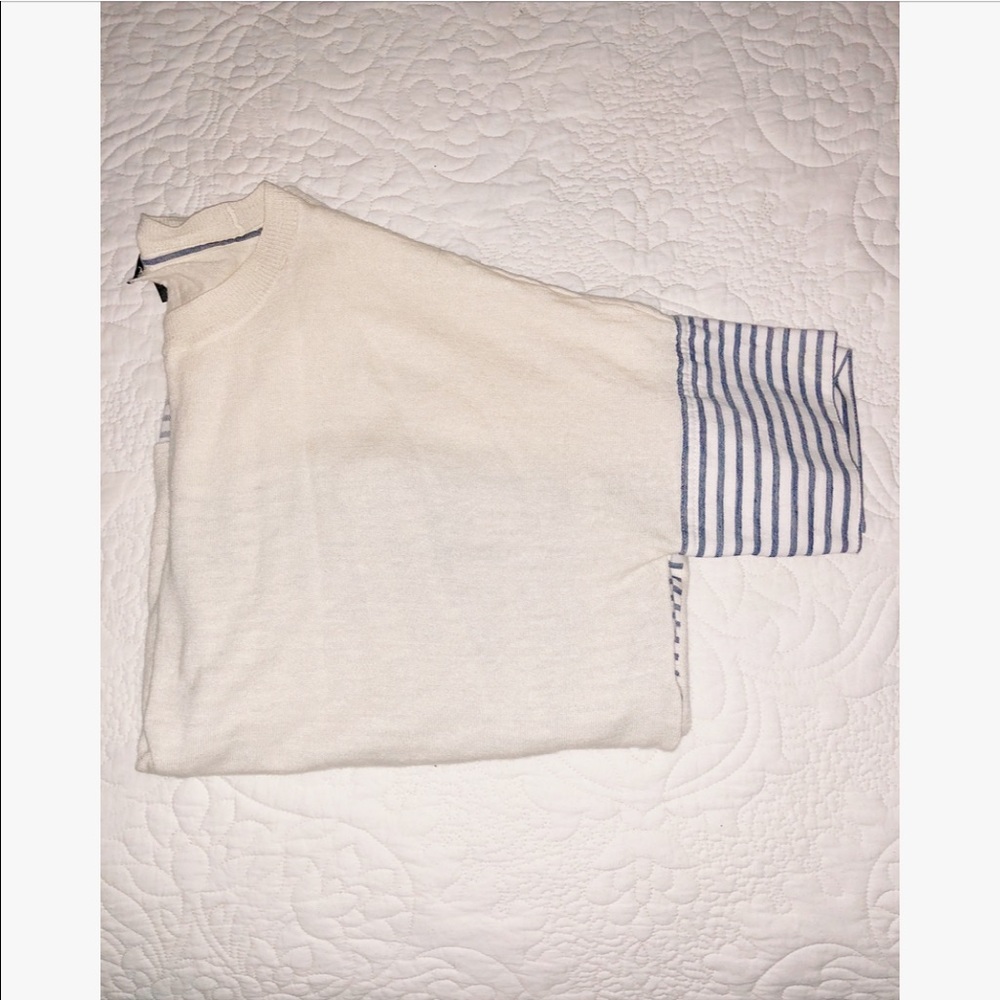 Cream top with a blue and white stripe accent